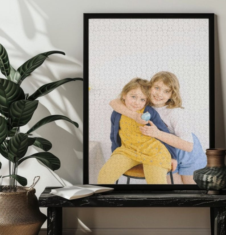 May include: Two young girls, one wearing a yellow dress and the other wearing a blue and white dress, are hugging each other. The girl in the yellow dress is holding a blue egg.