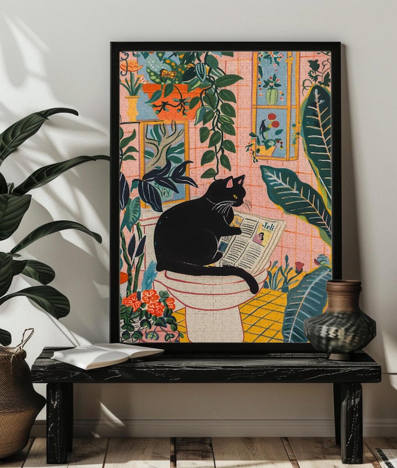 May include: A black cat sits on a white toilet reading a newspaper in a bathroom with pink walls and green plants. The newspaper has the word "Jell" printed on it.