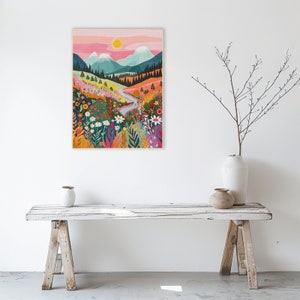 May include: A colourful illustration of a mountain landscape with a winding river and a variety of flowers. The sky is pink and orange, and the sun is shining.