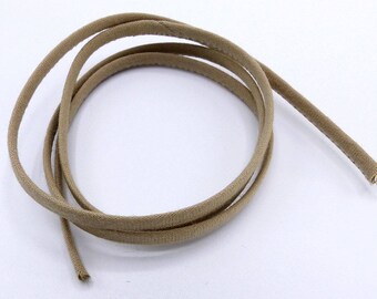 May include: A close-up of a beige fabric cord, coiled and ready for use. The cord is soft and flexible, perfect for crafting or DIY projects.