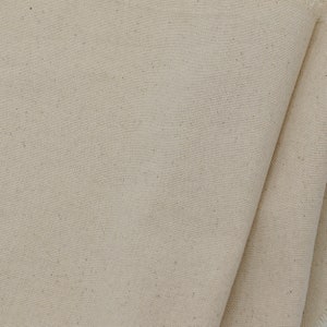 May include: Close-up of a natural beige canvas fabric with a subtle woven texture.