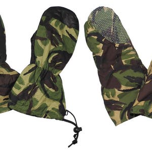 May include: A pair of camouflage mittens featuring a green, brown, and black pattern. The palms are solid black, while the backs display the camo print. The cuffs include an adjustable drawstring cord lock and a strap for a secure fit.