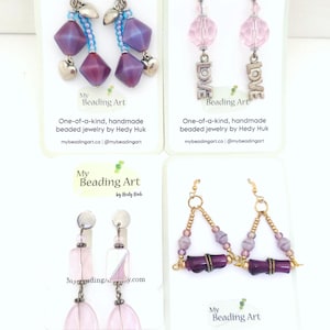 May include: Four pairs of handmade beaded earrings are shown on white cards. The earrings feature various designs with purple, pink, and gold beads. The cards include the text "My Beading Art" and "One-of-a-kind, handmade beaded jewelry by Hedy Huk."