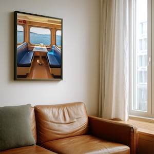 May include: A framed wall art print depicting the interior of a ferry or boat cabin. The scene features two blue bench seats facing each other with a small table in between, positioned in front of large windows overlooking the blue ocean water.