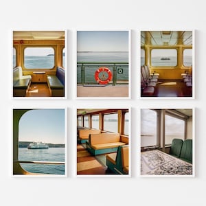 May include: Set of six framed art prints featuring ferry interiors and exteriors. The images showcase views of the sea, ferry seating, and a life preserver. The color palette includes shades of yellow, blue, and green, creating a serene nautical theme.