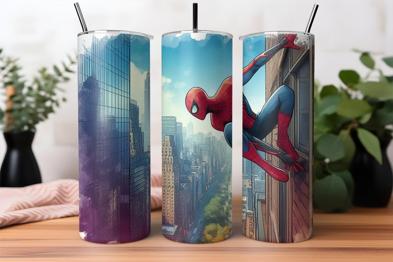 May include: Three stainless steel tumblers with a Spiderman design. The tumblers feature a cityscape background with Spiderman swinging through the city. One tumbler has a purple and blue cityscape, one has a blue cityscape, and one has a cityscape with Spiderman swinging from a building.