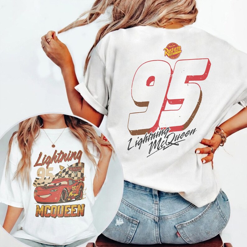 May include: White t-shirt featuring a graphic of Lightning McQueen from the movie Cars. The design includes the number 95, the words "Lightning McQueen", and the Rust-eze logo. The shirt is a casual, comfortable style.