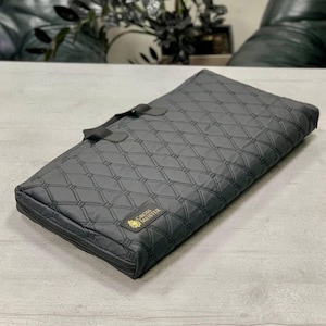 May include: A black quilted carrying case with a gold logo that reads "CROSS MASTER".