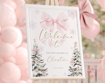 May include: A baby shower welcome sign on a wooden easel. The sign is white with a pink bow and text that reads "Welcome to The Baby Shower of Christina". Pink balloons and floral arrangements decorate the background.
