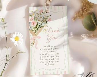 May include: A floral thank you tag with a bouquet of flowers tied with a pink ribbon. The tag has the words "Thank You" and a message of gratitude. The tag is from Alice Paper Boutique.