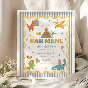 May include: A rectangular bar menu sign with a blue and white striped border and a yellow scalloped frame. It features cartoon dinosaurs, a volcano, and balloons. The text reads: Let's enjoy! BAR MENU, Amaretto Sour, Aperol Spritz, and Mojito.