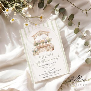 May include: A floral market-themed invitation with a watercolor illustration of a flower stand. The invitation features the text "FRESH off the market" and event details. The design includes a light green striped background and floral accents.