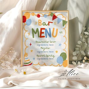 May include: A rectangular bar menu sign in a gold frame featuring a light blue and white checkered background. The text reads Bar MENU with Amaretto Sour, Mojito, and Aperol Spritz listed. It is decorated with colorful balloons, bunting, and a party hat.