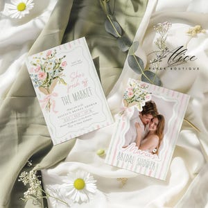 May include: Two bridal shower invitations with floral bouquets and text. One says "She's fresh off the market" and the other features a couple. The invitations have pink and green stripes and are on a white and green fabric.
