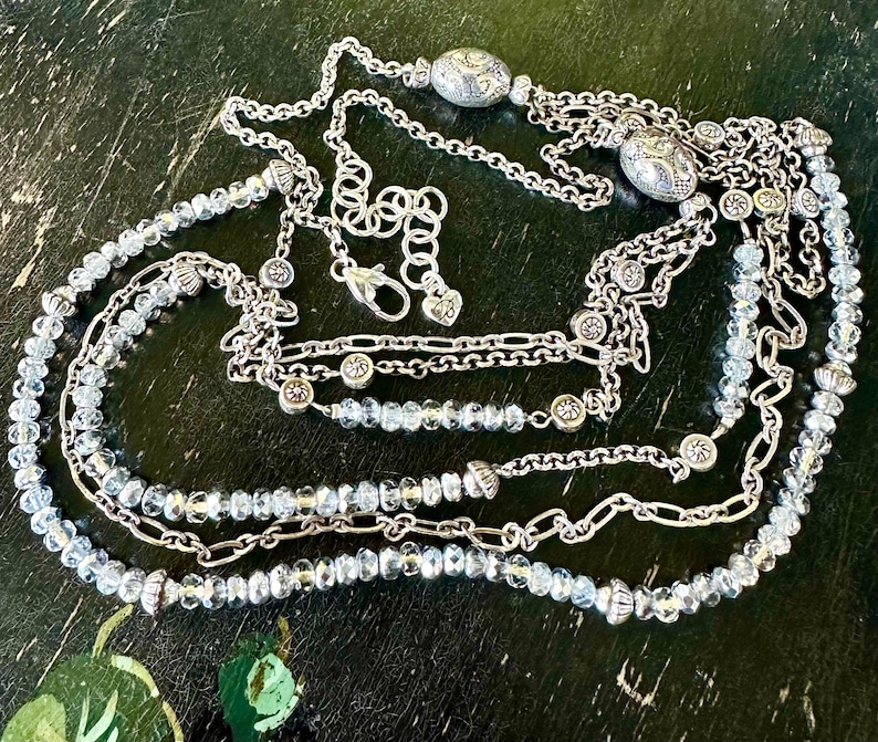 May include: A set of three ceramic nesting bowls in shades of blue, green, and white. The bowls feature a speckled glaze and a simple, modern design. The largest bowl measures approximately 6 inches in diameter.