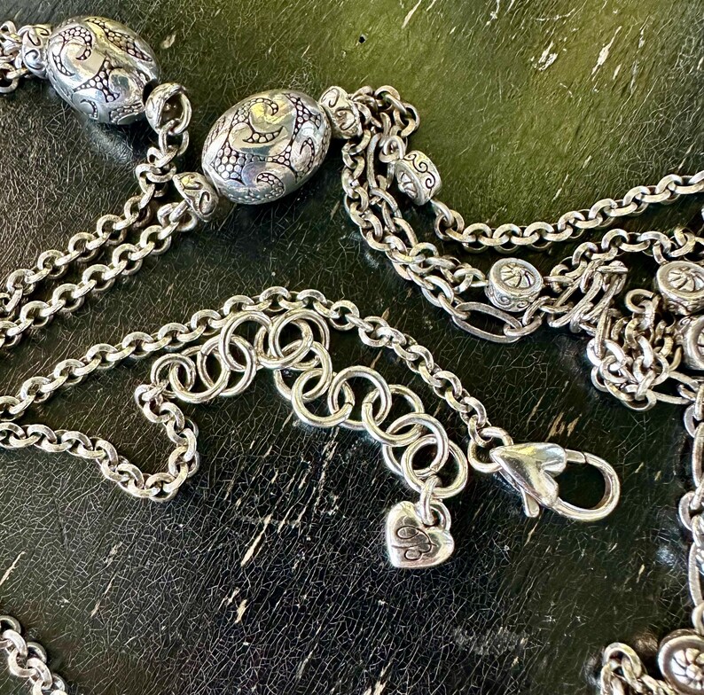 May include: A white ceramic mug with a black handle and the text "But First, Coffee" in a bold, black font. The mug is sitting on a wooden surface. The mug is approximately 4 inches tall.