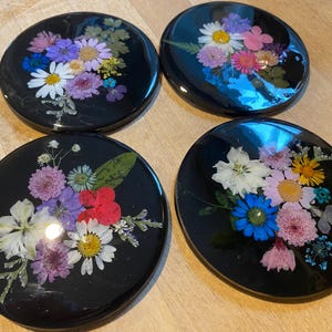 Set of four black and dried flower coasters