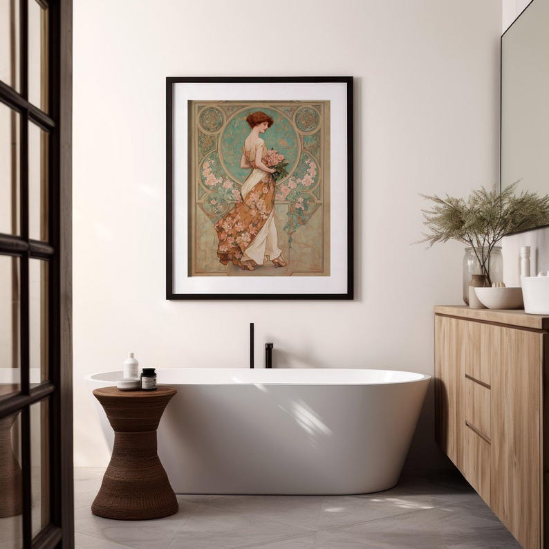 May include: A framed art print featuring a woman in a flowing gown holding flowers. The artwork has a vintage style with a color palette of greens, browns, and pinks. The print is displayed in a modern bathroom setting with a white bathtub and wooden accents.