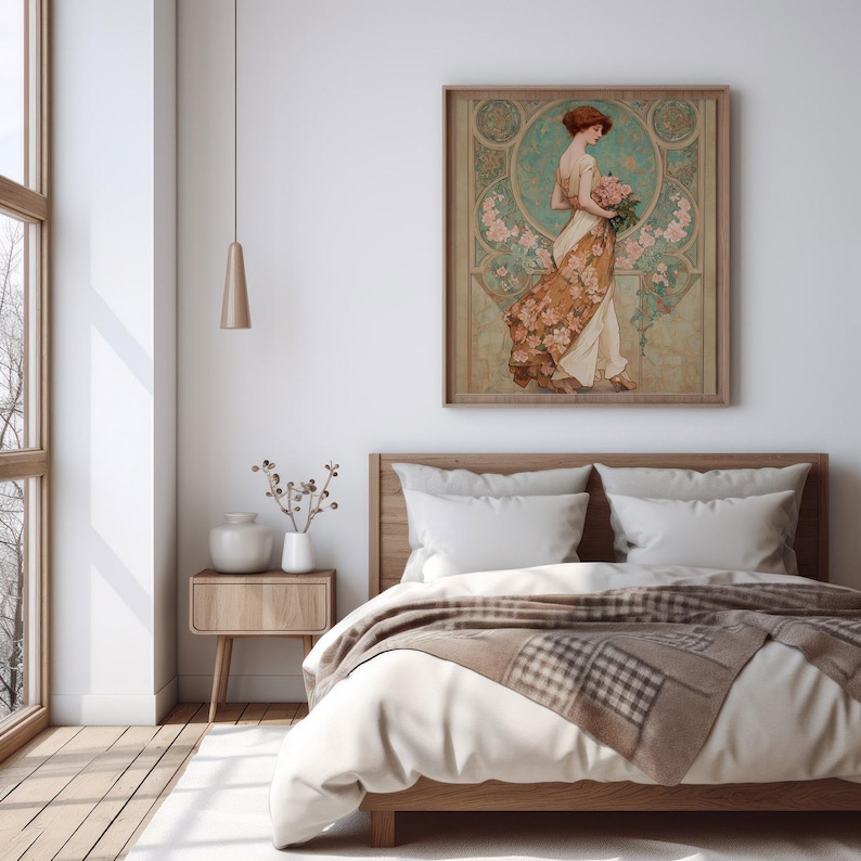 May include: A framed art print featuring a woman in a flowing dress holding flowers. The artwork has a vintage style with a color palette of beige, brown, and teal. The print hangs above a wooden bed with white bedding and a patterned throw.