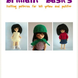 May include: A book cover with the title "brilliant basics" in purple, featuring three dolls wearing knitted outfits. The text below reads "Knitting patterns for lati yellow and pukifee" in orange. The author's name, "anna waites," is at the bottom.