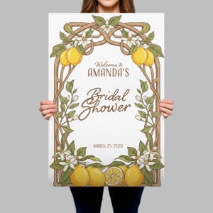 May include: A white poster with a brown decorative border featuring lemons, flowers, and leaves. The text reads "Welcome to AMANDA'S Bridal Shower" and "March 25, 2026". The design has a vintage, botanical theme.