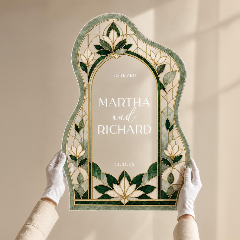 May include: An arched, wavy-edged sign featuring a stained glass-style border in shades of dark green, cream, and gold. The center is clear with white text reading FOREVER, MARTHA and RICHARD, and 10.01.26. The design includes floral motifs.