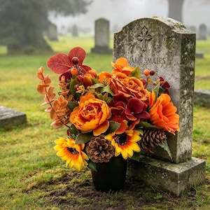 Autumn grave pot oranges yellows pine cones sun flowers, deep reds roses mixed foliage Grave pot cemetery pot. Memorial Tribute