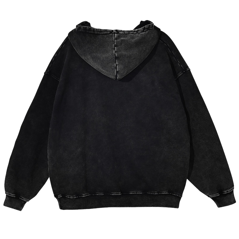 May include: Black hooded sweatshirt with a faded, distressed look. The hoodie has a drawstring hood, long sleeves, and ribbed cuffs and hem. The back view shows the stitching details of the hood.