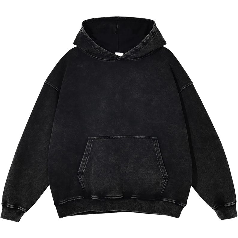 May include: A black hoodie with a washed, vintage appearance. The sweatshirt has a hood, a kangaroo pocket, and ribbed cuffs and hem. The fabric has a slightly faded look, giving it a worn aesthetic. The hoodie is a casual, comfortable garment.