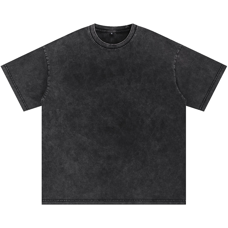 May include: A charcoal grey, short-sleeved t-shirt with a crew neck. The shirt has a faded, vintage wash appearance. The fabric appears soft and slightly textured. The overall style is casual and relaxed.