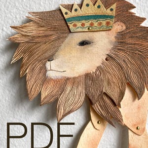 Può includere: Un burattino di leone in cartapesta con una criniera marrone e una corona dorata con accenti blu e rossi. Il burattino è articolato con chiusure in ottone. La parola "PDF" è stampata in nero nella parte inferiore dell'immagine.