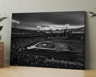 May include: Black and white photograph of a baseball stadium at night. The stadium is full of fans and the field is lit up. The words "Boston Red Sox" are visible on the field.