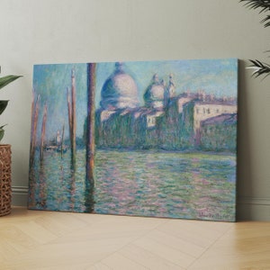May include: A painting of a canal in Venice, Italy. The water is a light blue-green color and there are several boats in the distance. The buildings on the other side of the canal are a pale yellow color and have a dome-shaped roof. The painting is done in a style that is reminiscent of Impressionism.