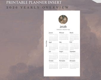 May include: A printable planner insert with a 2026 yearly overview. The white insert features a calendar layout with months and dates. The text "2026" and "Twenty Twenty Six" are displayed at the top. The insert is personal size, measuring 3.74 inches by 6.73 inches.
