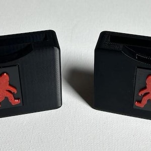 May include: Two black plastic cases with a red silhouette of a Bigfoot on the front. Each case has a slot for a game cartridge.