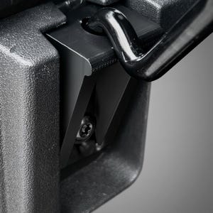 May include: A black metal latch mechanism featuring a textured matte finish, a curved hook component, and a central star-shaped screw head. The assembly is integrated into a rigid, molded black housing with a distinct industrial design.