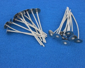 May include: A close-up of two piles of white candle wicks with metal bases. The wicks are arranged in a fan shape and are ready to be used in candle making.