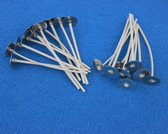 May include: A close-up of two piles of white candle wicks with metal bases. The wicks are arranged in a fan shape and are ready to be used for candle making.