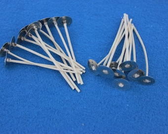 May include: A close-up of two piles of white candle wicks with metal bases. The wicks are arranged in a fan shape and are ready to be used for candle making.