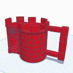 May include: A red ceramic mug shaped like a castle with a brick pattern and a handle. The castle has a small tower with a window and a staircase leading up to it.