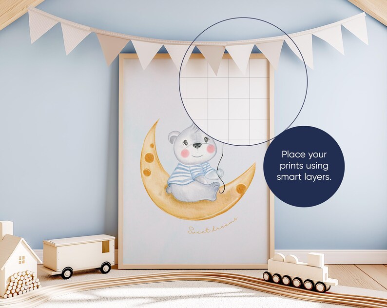 May include: A watercolor illustration of a gray bear wearing a blue and white striped shirt sitting on a yellow crescent moon. The text "Sweet Dreams" is written below the bear. The illustration is framed and hanging on a light blue wall.