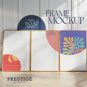 May include: Three framed art prints with gold frames. The prints are on white paper with colorful abstract designs. The prints are titled "BERGGRUEN", "ATISSE", and "PAPIERS DECOUPES". The text "FRAME MOCKUP" and "PRESTIGE ART MOCKUPS" is also visible.