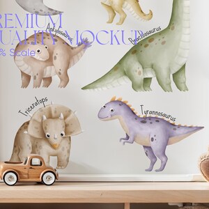 May include: A white framed print with watercolor illustrations of different dinosaurs. The dinosaurs are labeled with their names: Ankylosaurus, Brachiosaurus, Triceratops, and Tyrannosaurus. The print is on a wooden shelf with a toy truck and a teddy bear.