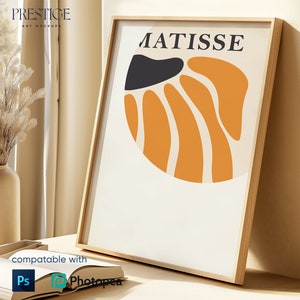 Puede incluir: Una impresión de arte enmarcada con un diseño abstracto minimalista en naranja, negro y blanco. La impresión presenta la palabra "MATISSE" en texto negro en la parte superior.