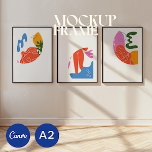 May include: Three framed abstract art prints with black frames. Each print features colourful, geometric shapes in red, orange, blue, yellow, and green on a white background. The text "MOCKUP FRAME" is at the top, and the text "Canva" and "A2" are at the bottom.