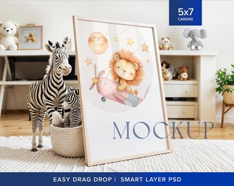 May include: A 5x7 inch canvas mockup with a white frame, featuring a watercolor illustration of a lion flying a pink airplane with stars and a moon in the background. The mockup is placed on a white rug in a nursery setting with stuffed animals and a wooden shelf.