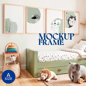 May include: A child's bedroom scene featuring framed animal art prints, a green bed, and plush toys. The prints have a light wood frame and feature a bird, a cat, and a monkey. The text "MOCKUP FRAME" is visible. A size label says "A SIZE".