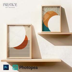 May include: Two framed abstract art prints with geometric shapes and patterns in shades of orange, teal, white, and black. The prints are displayed on two wooden shelves against a white wall.