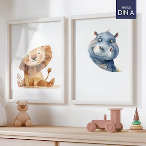 Könnte beinhalten: Zwei gerahmte Aquarell-Illustrationen von Tieren. Der linke Rahmen zeigt einen braunen Löwen mit einer hellbraunen Mähne. Der rechte Rahmen zeigt ein blaues Flusspferd mit einer rosa Nase. Der Text "RATIOS DIN A" ist in der oberen rechten Ecke des Bildes gedruckt.
