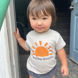 Kid t-shirt with sun design that says "Good Day Sunshine."